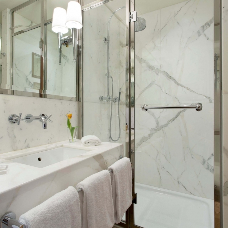 Marble bathroom with luxurious shower. Guest amenities.